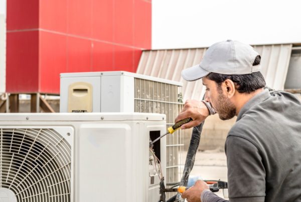 Electrician fixing ac unit