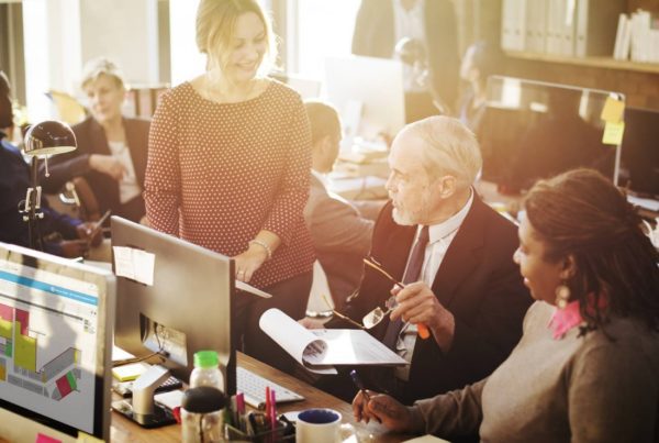 business people gathered around desk